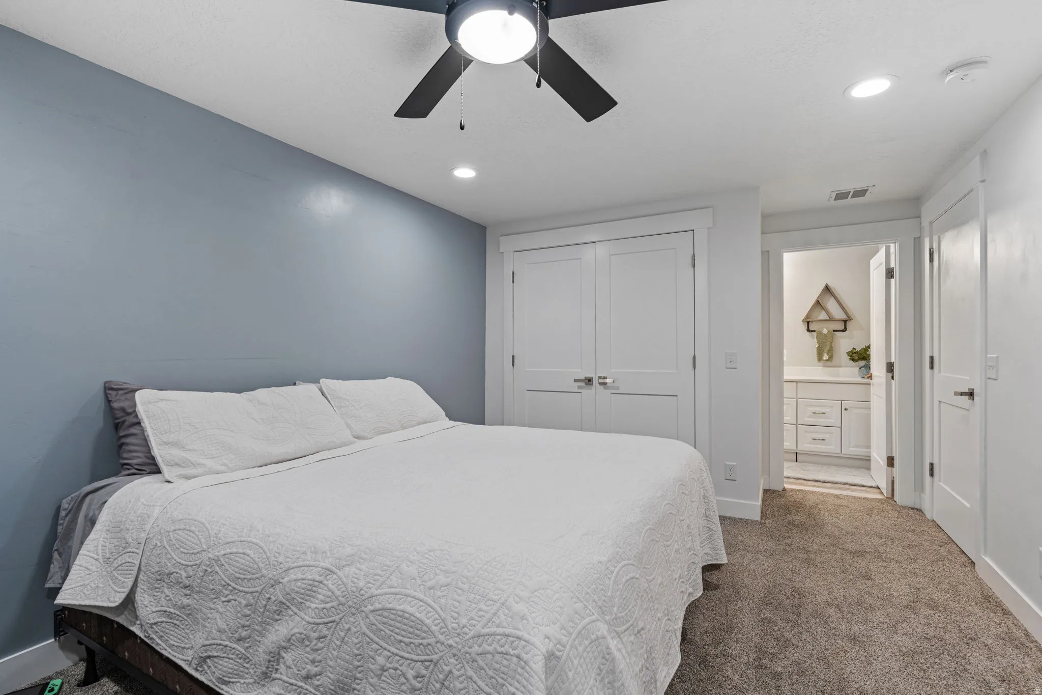 Bedroom featuring a closet, a ceiling fan, recessed lighting, and carpet