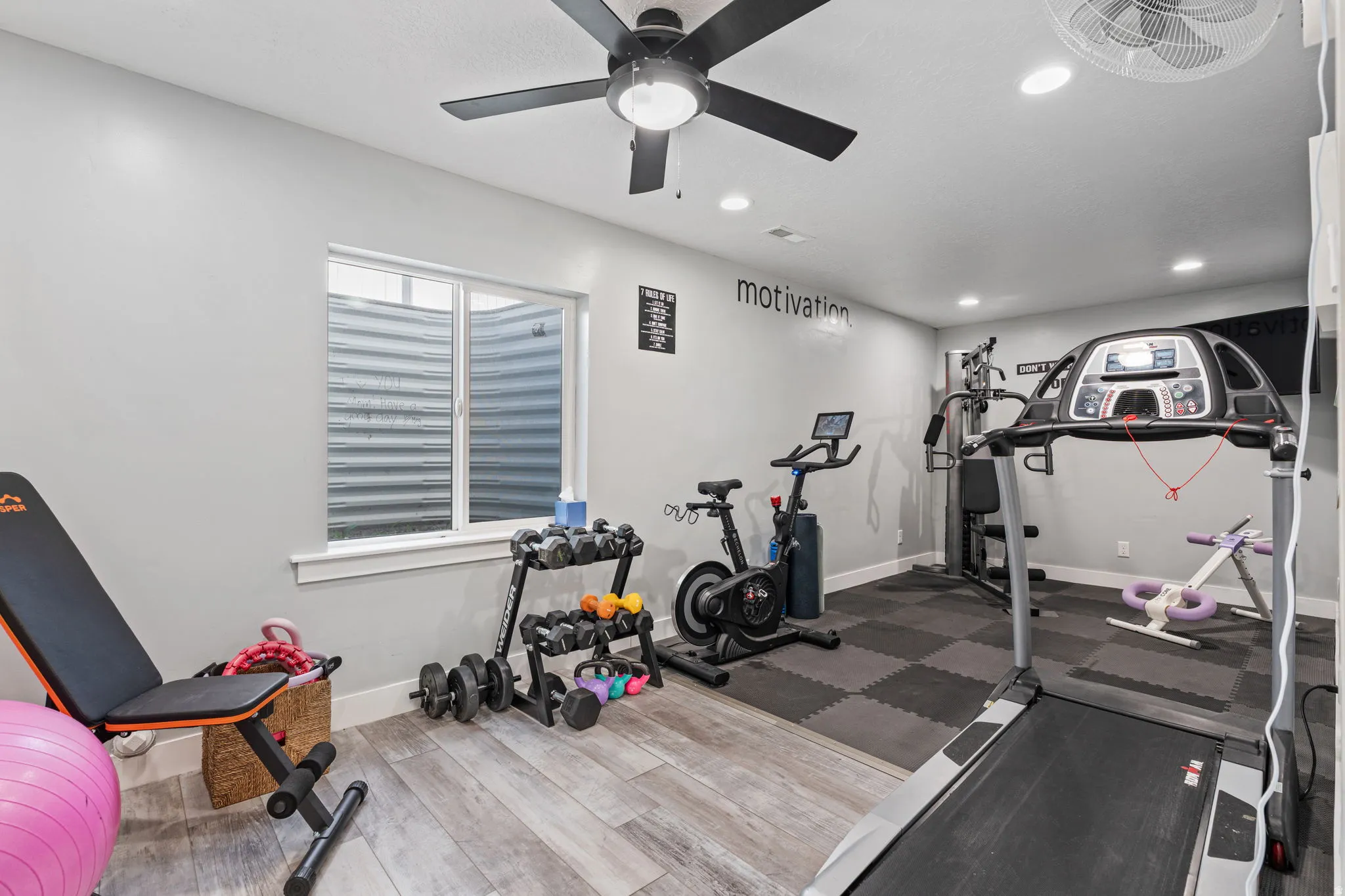 Workout room with a ceiling fan, recessed lighting, and dark wood finished floors