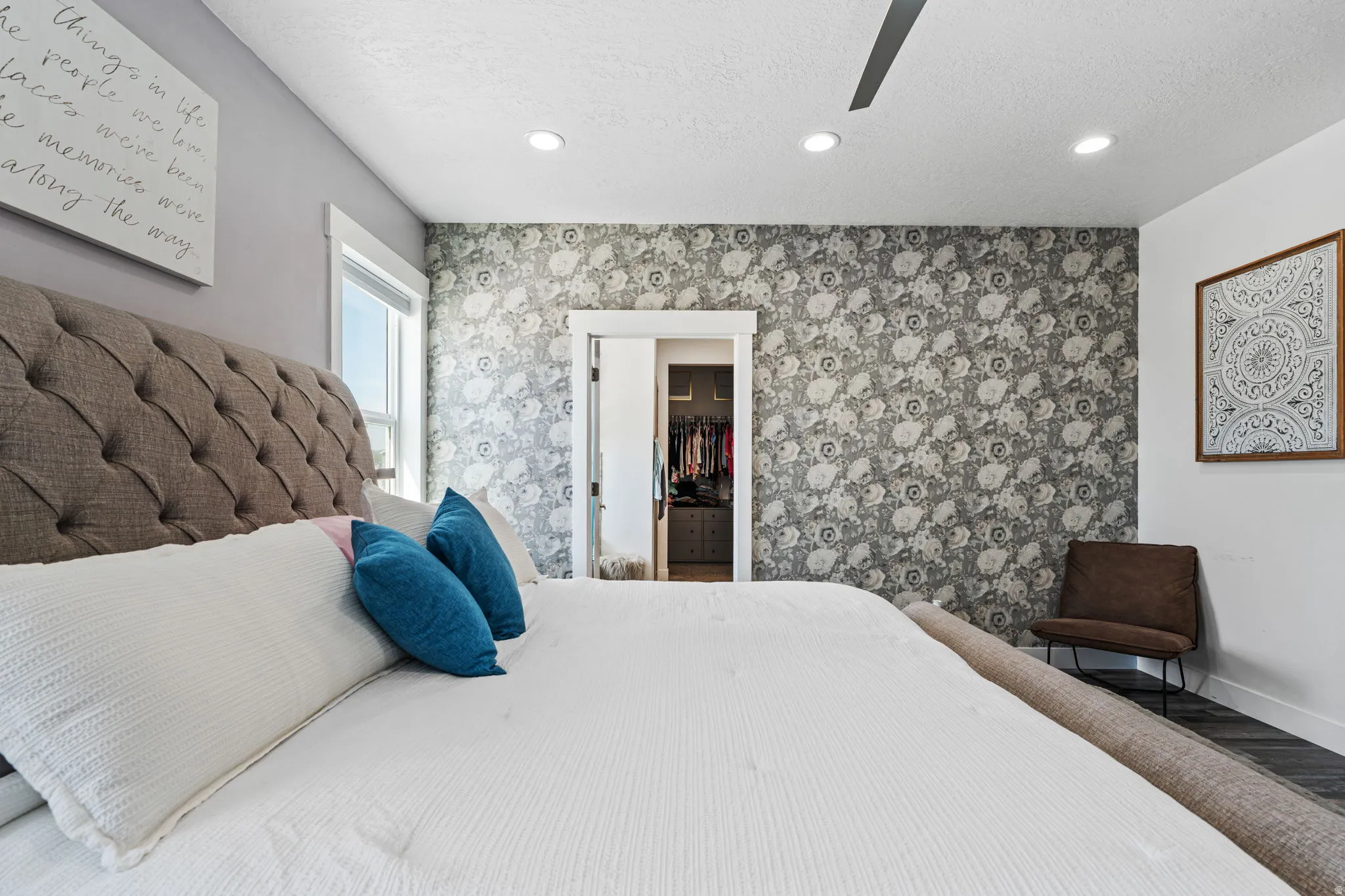 Bedroom with recessed lighting, a textured ceiling, a ceiling fan, an accent wall, and wood finished floors
