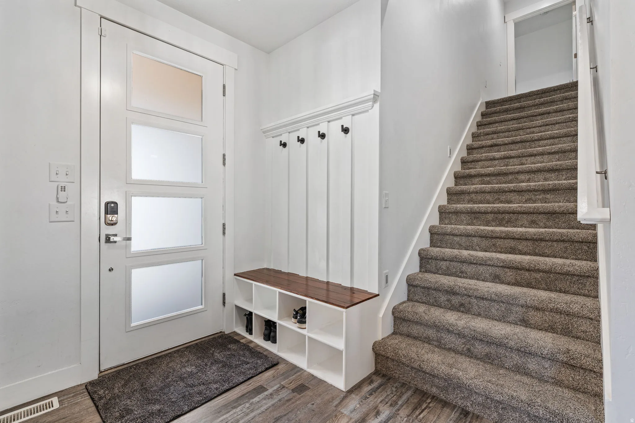 Mudroom with dark wood-style flooring