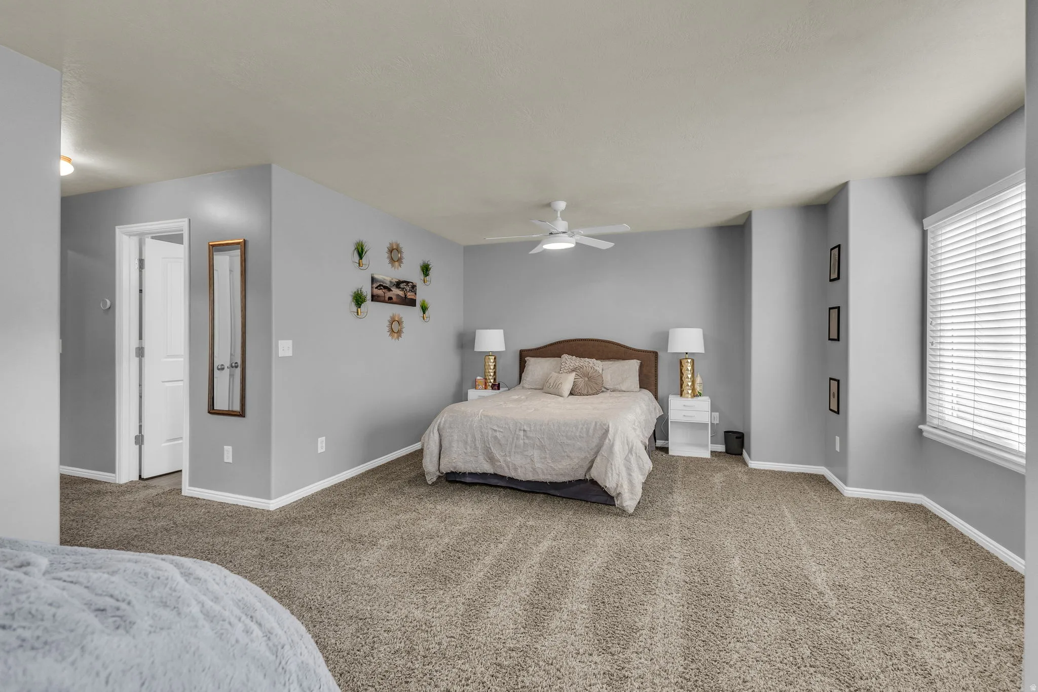 Carpeted bedroom with baseboards and ceiling fan