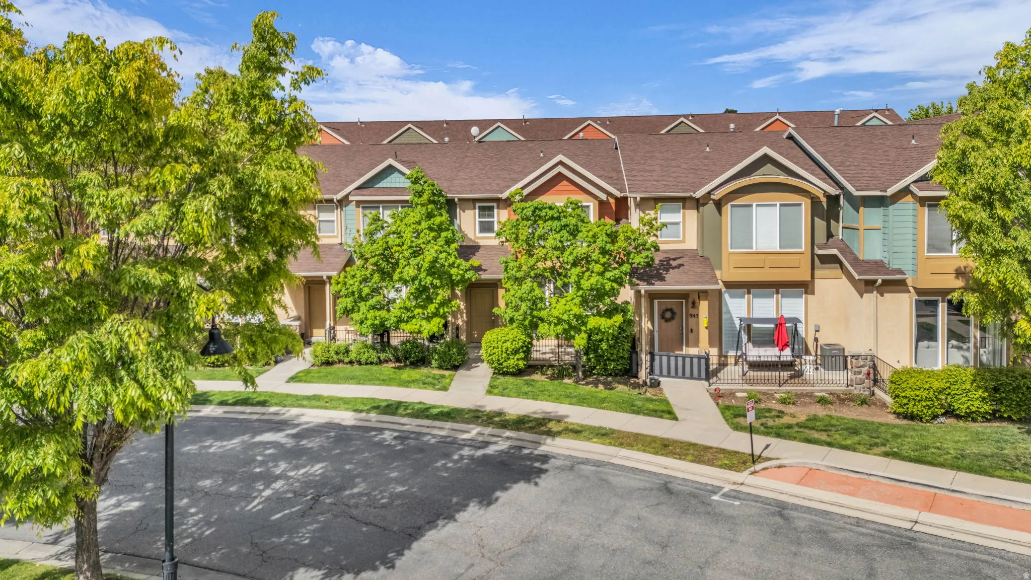 Traditional-style house with stucco siding and roof with shingles
