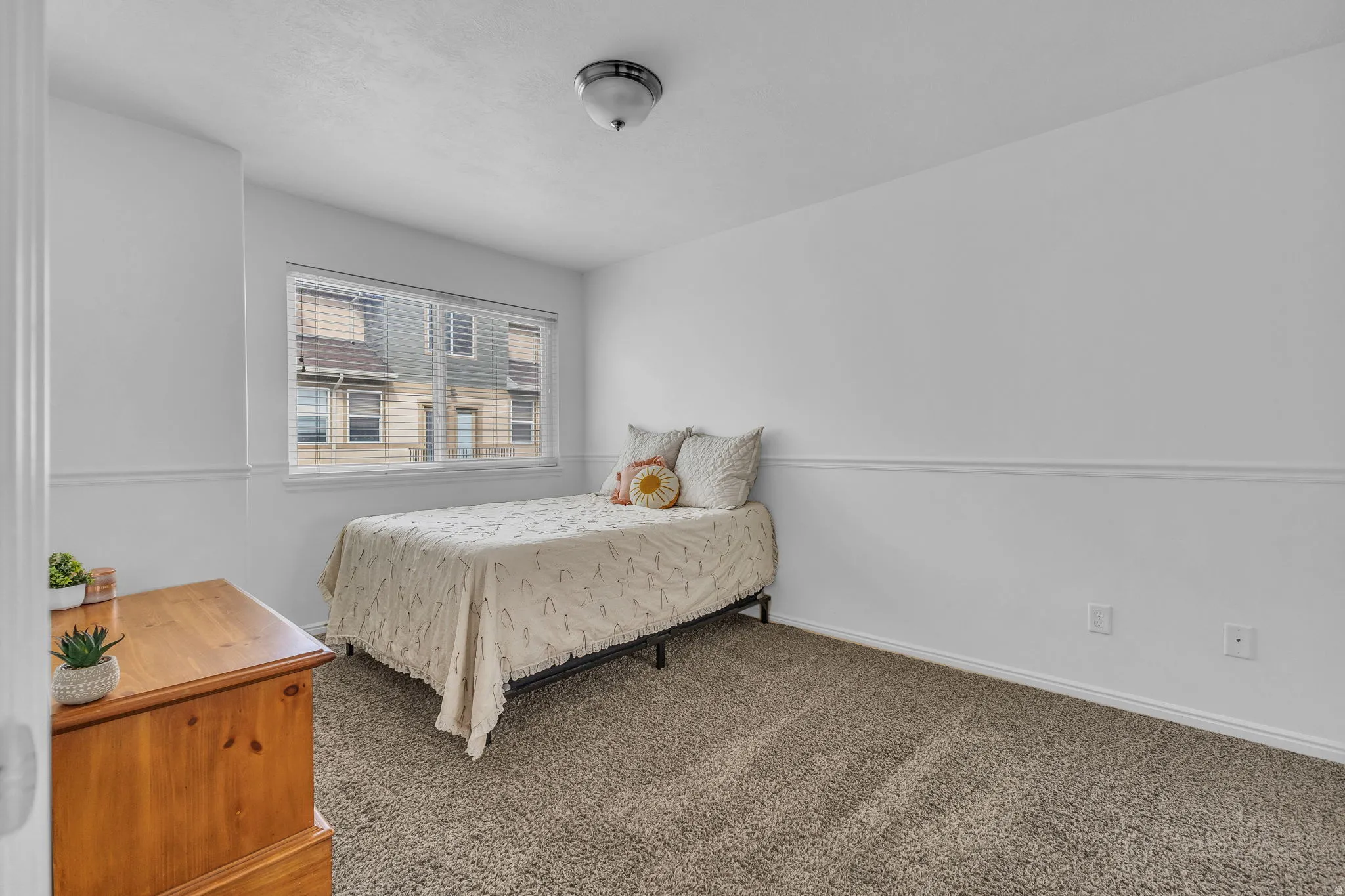 Carpeted bedroom featuring baseboards