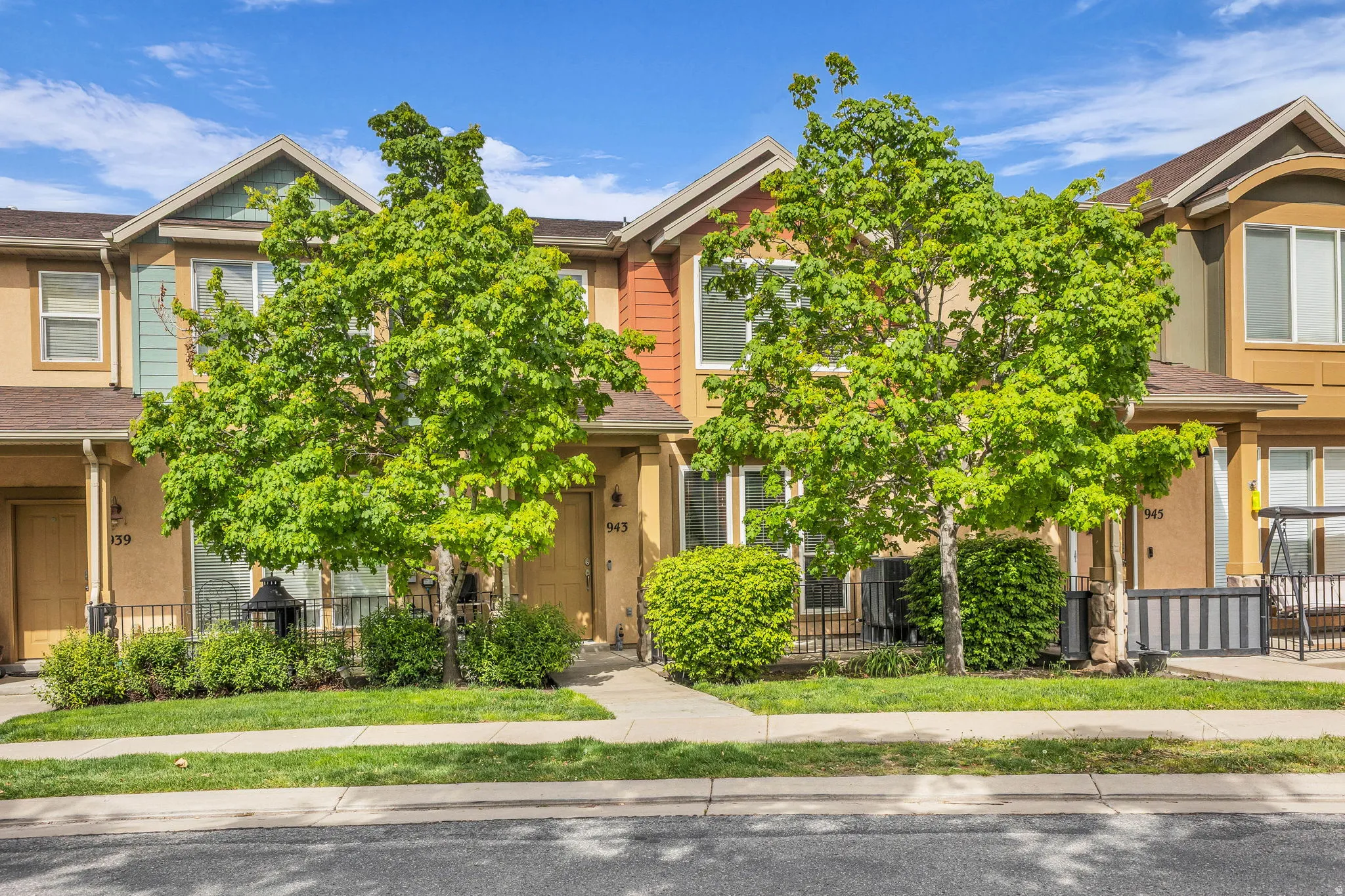 View of property hidden behind natural elements featuring a fenced front yard