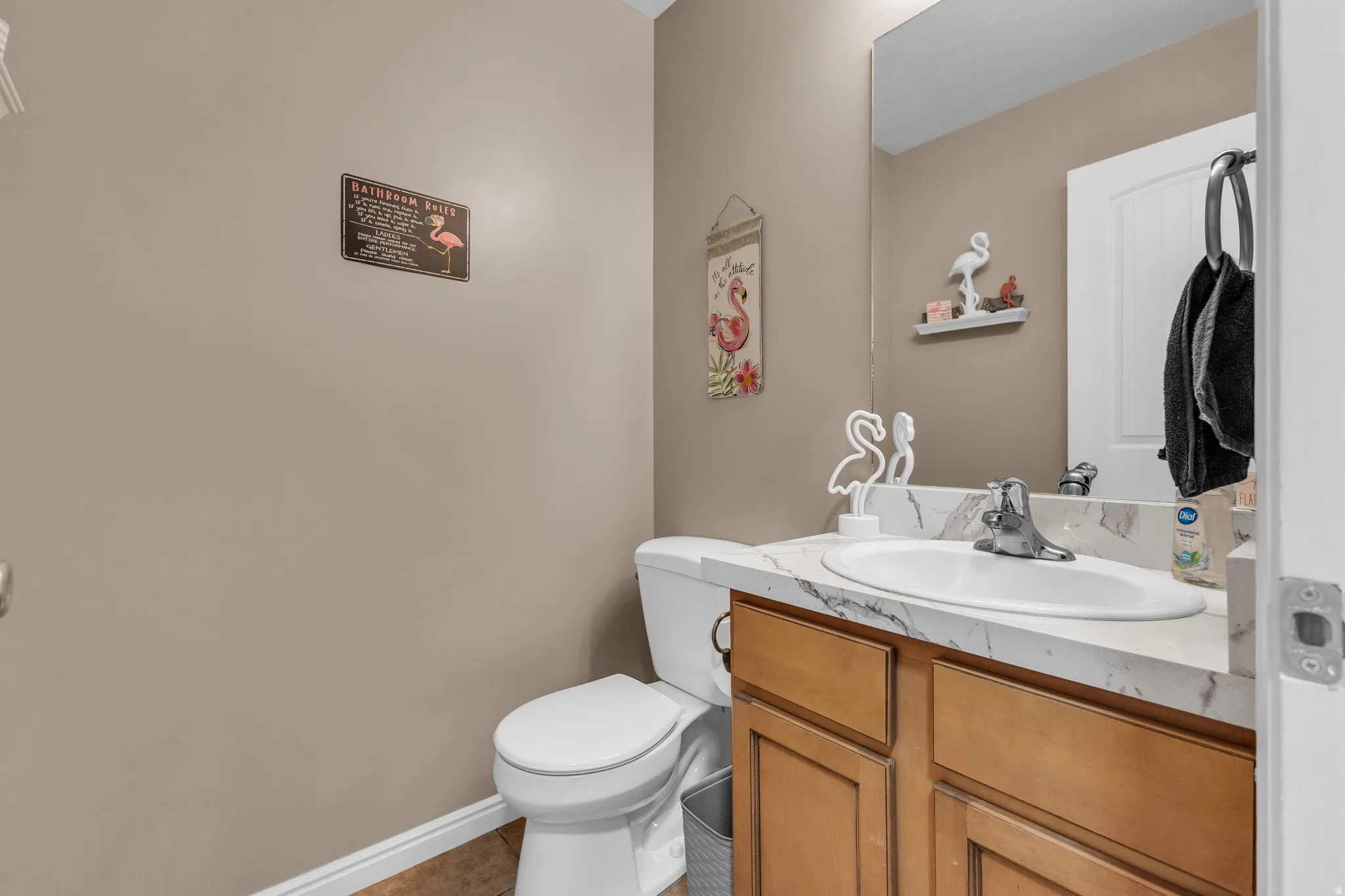 Half bathroom featuring vanity and toilet