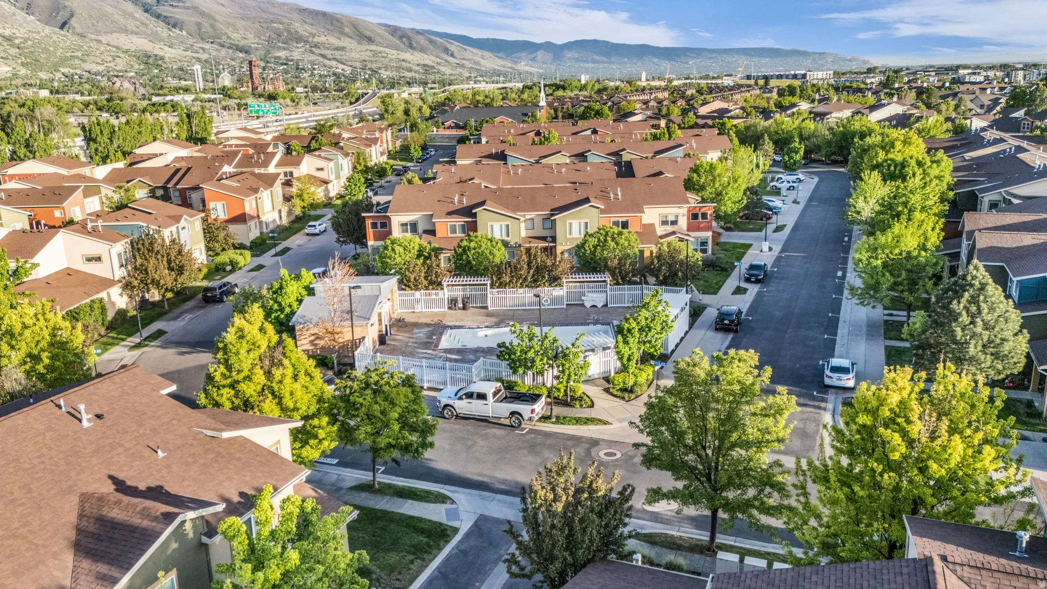 Aerial perspective of suburban area featuring a mountain backdrop