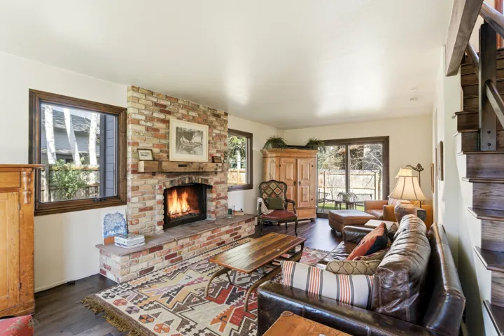 Living area with dark wood-style flooring and a fireplace