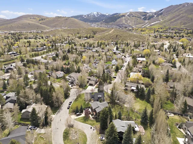 Aerial overview of property's location with mountains and nearby suburban area