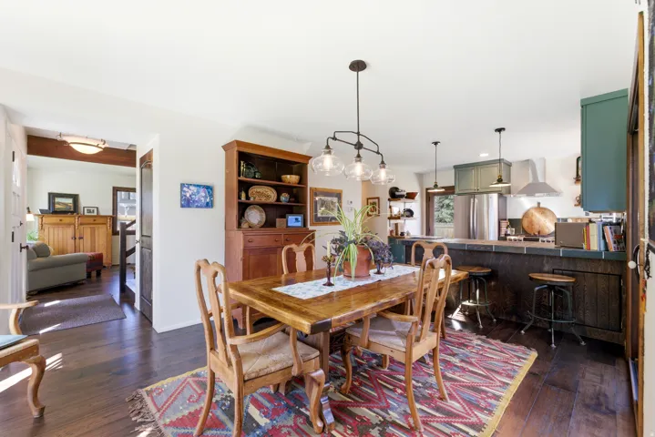 Dining area featuring dark wood-style flooring