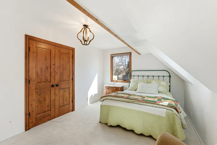 Carpeted bedroom with hanging lights