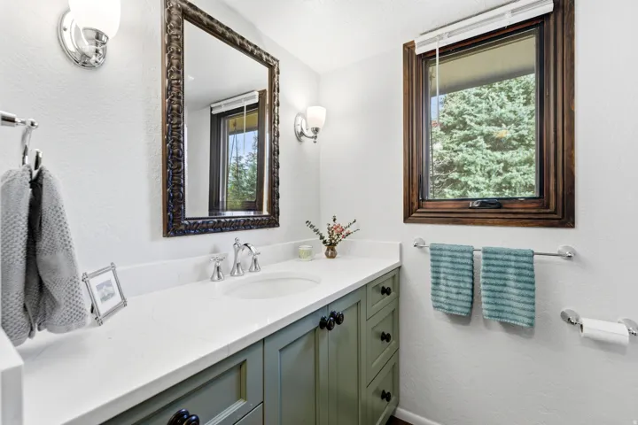 Bathroom featuring a textured wall and vanity