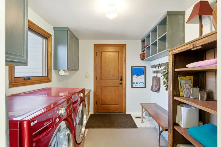Laundry room featuring independent washer and dryer and cabinet space