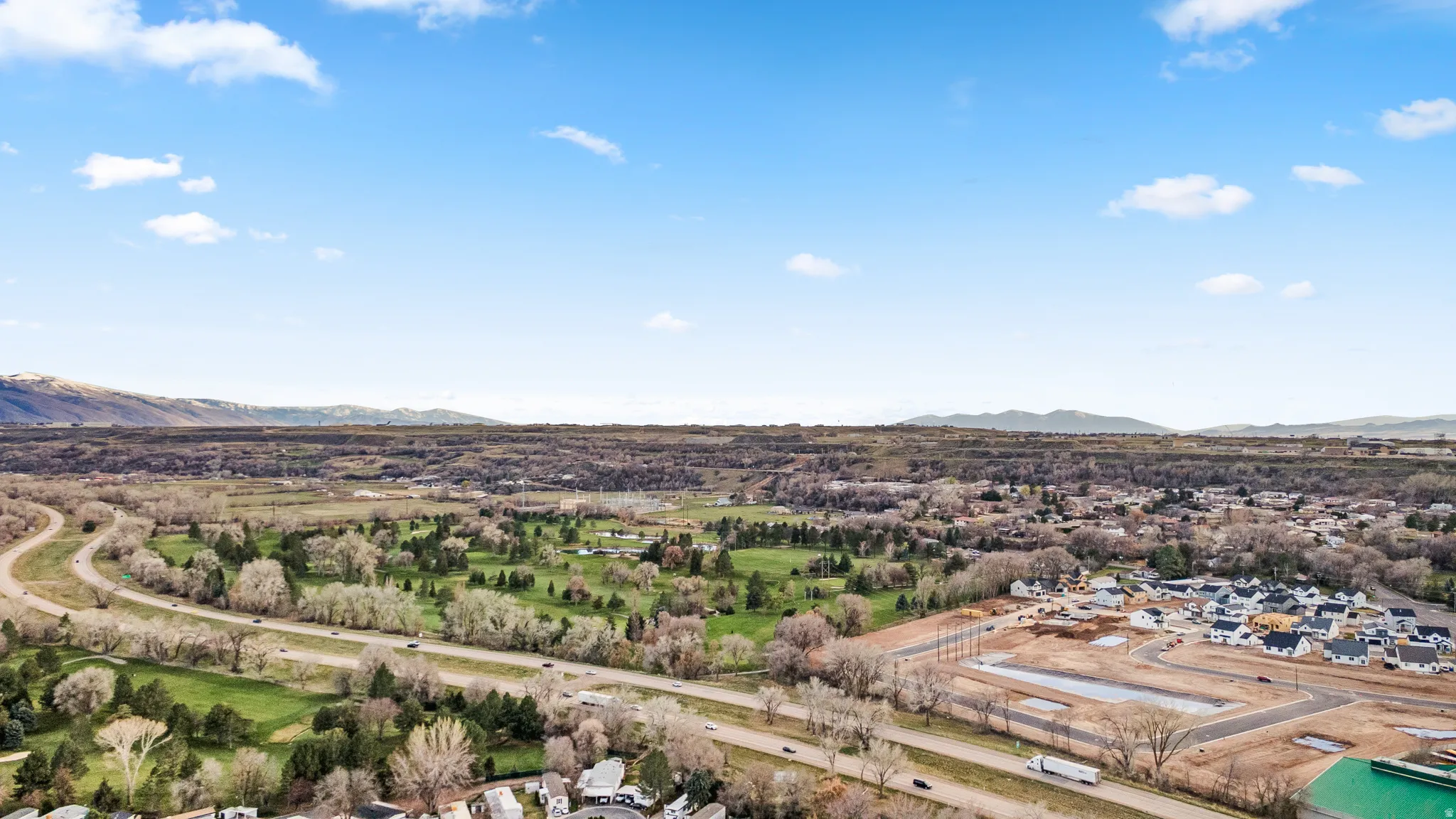 Aerial perspective of suburban area with a mountainous background