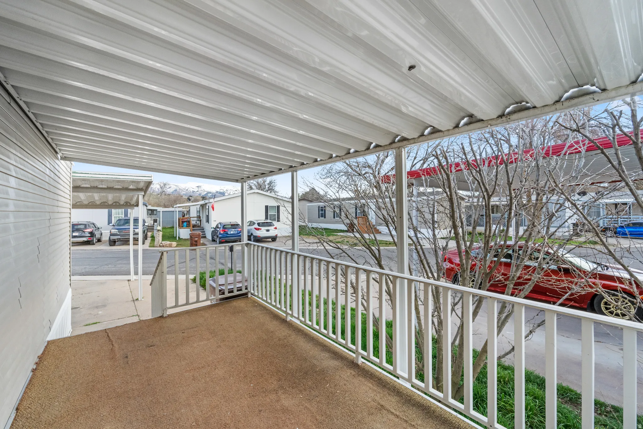 Covered porch featuring a residential view