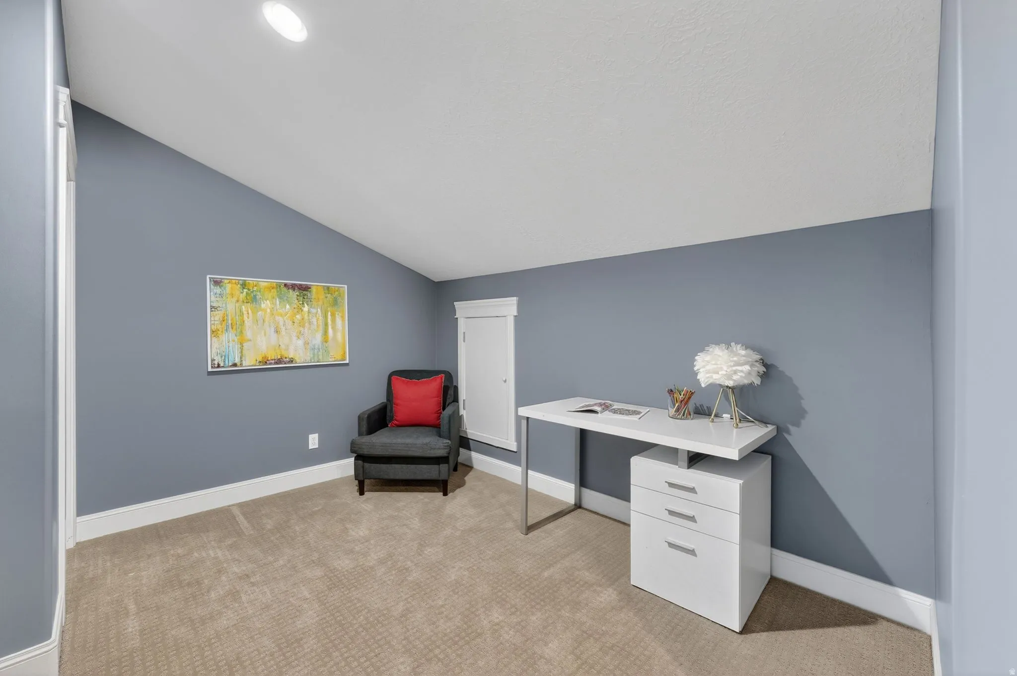 Office with light carpet and lofted ceiling