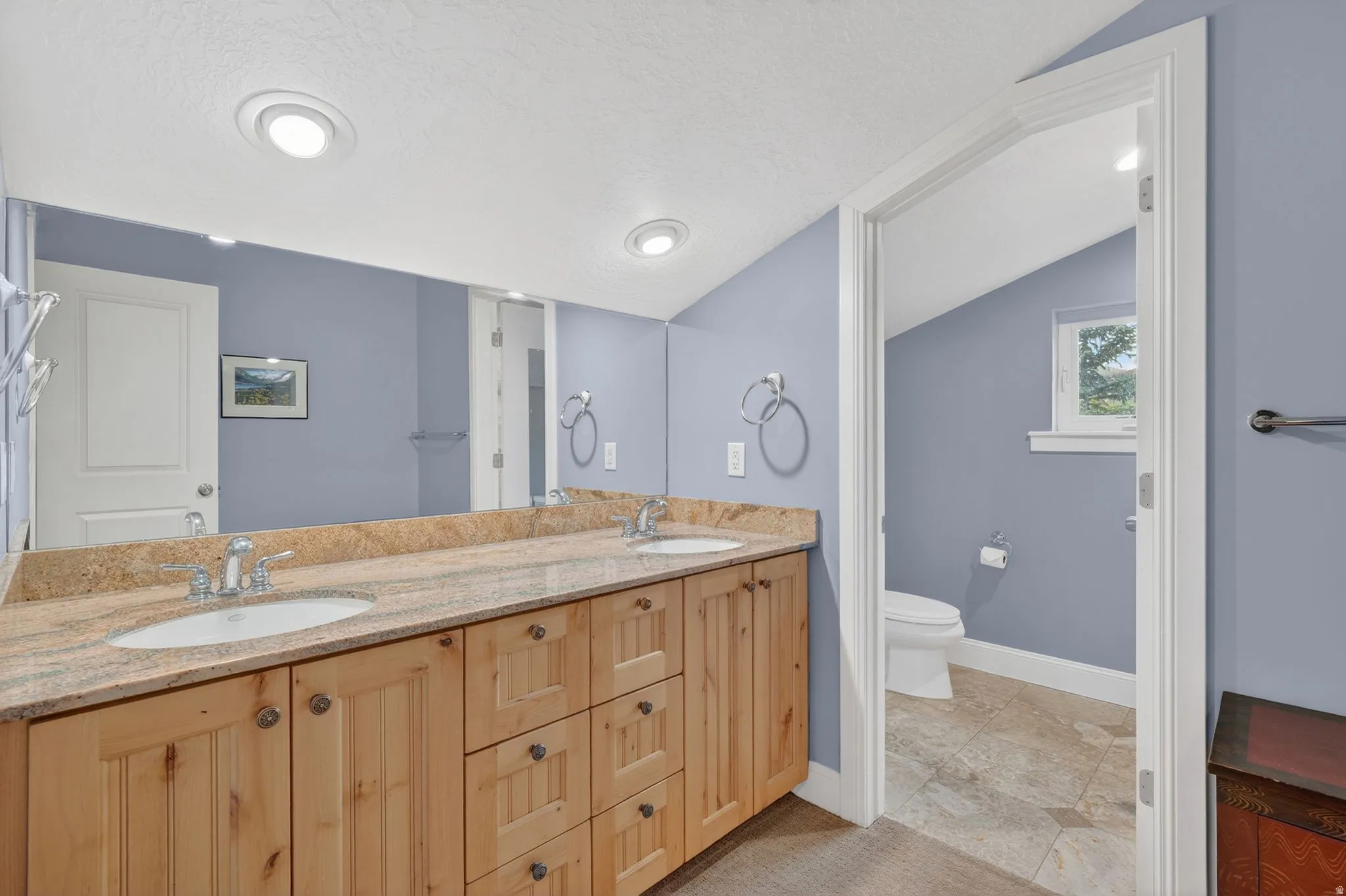 Full bathroom with double vanity and recessed lighting
