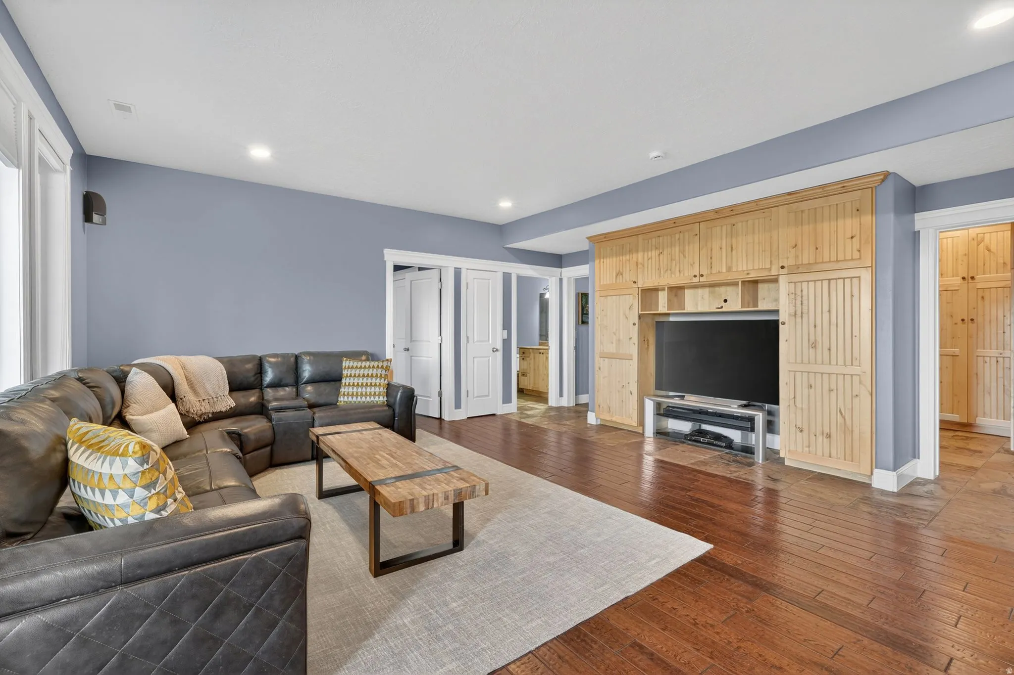 Living room featuring dark wood-style floors and recessed lighting
