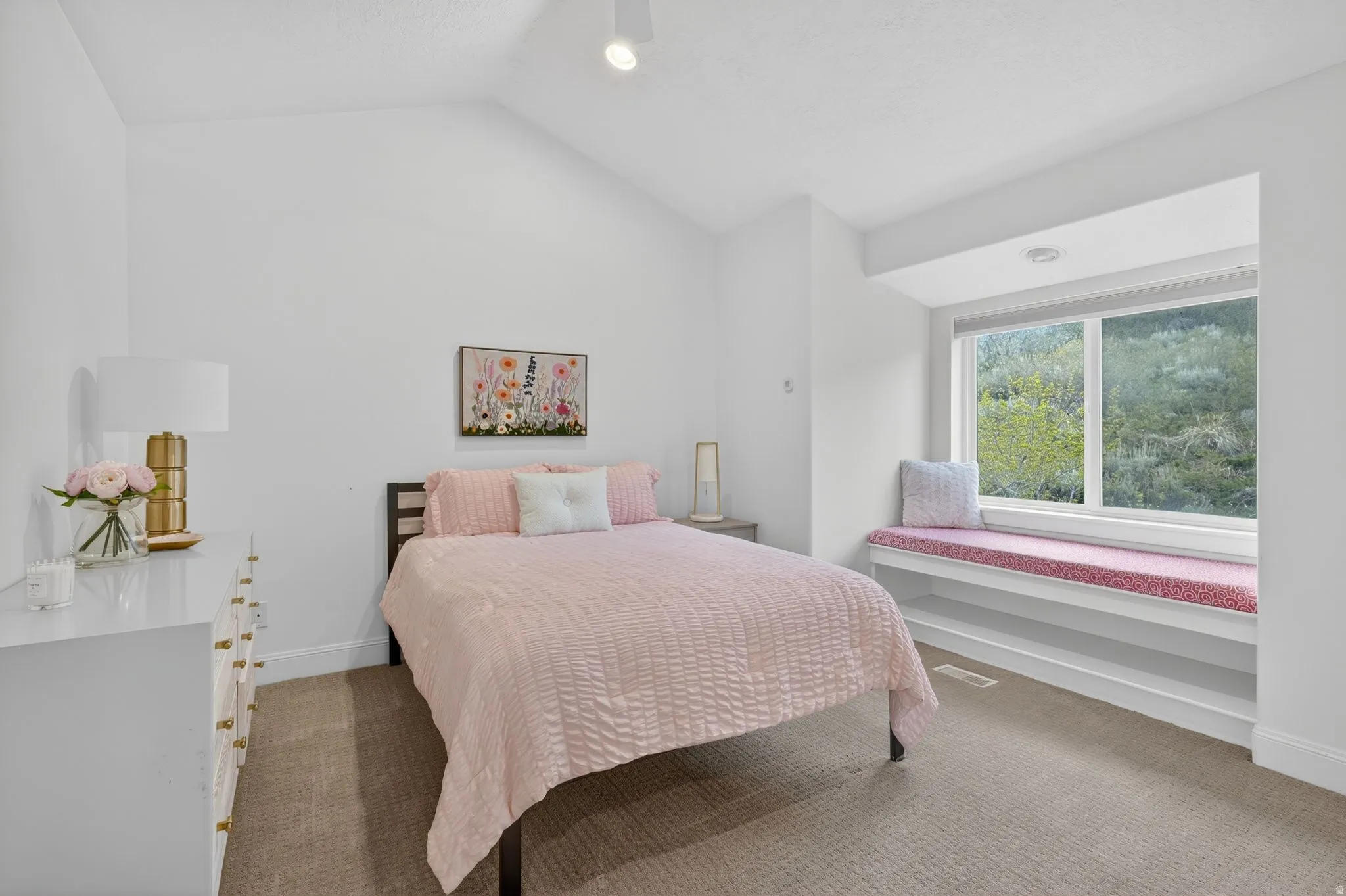 Bedroom with carpet flooring and lofted ceiling