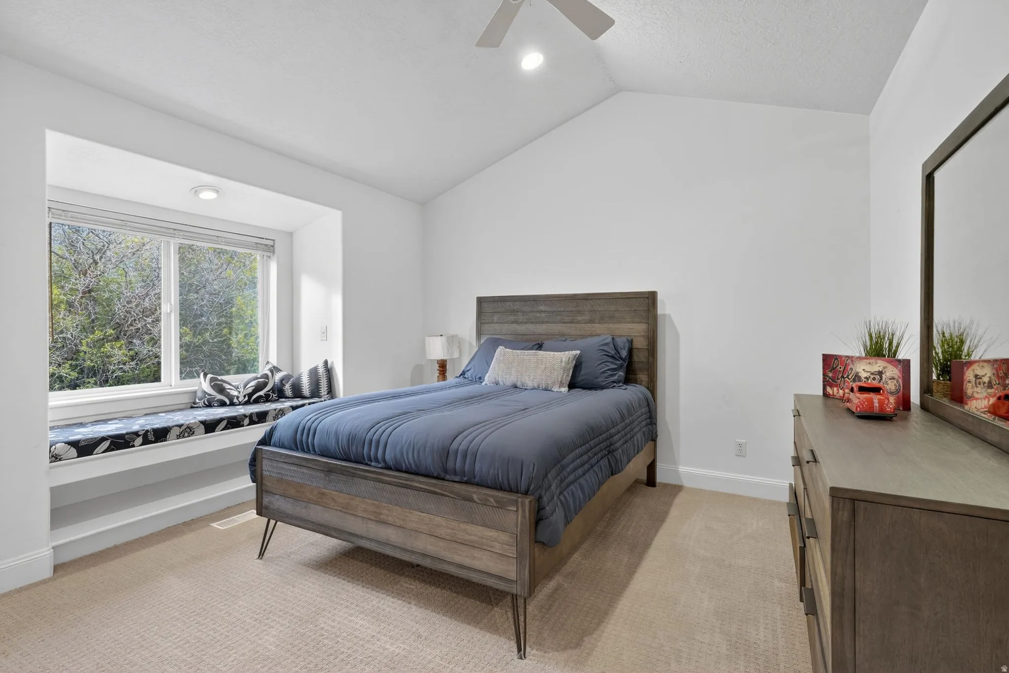 Bedroom featuring light colored carpet, lofted ceiling, ceiling fan, and recessed lighting