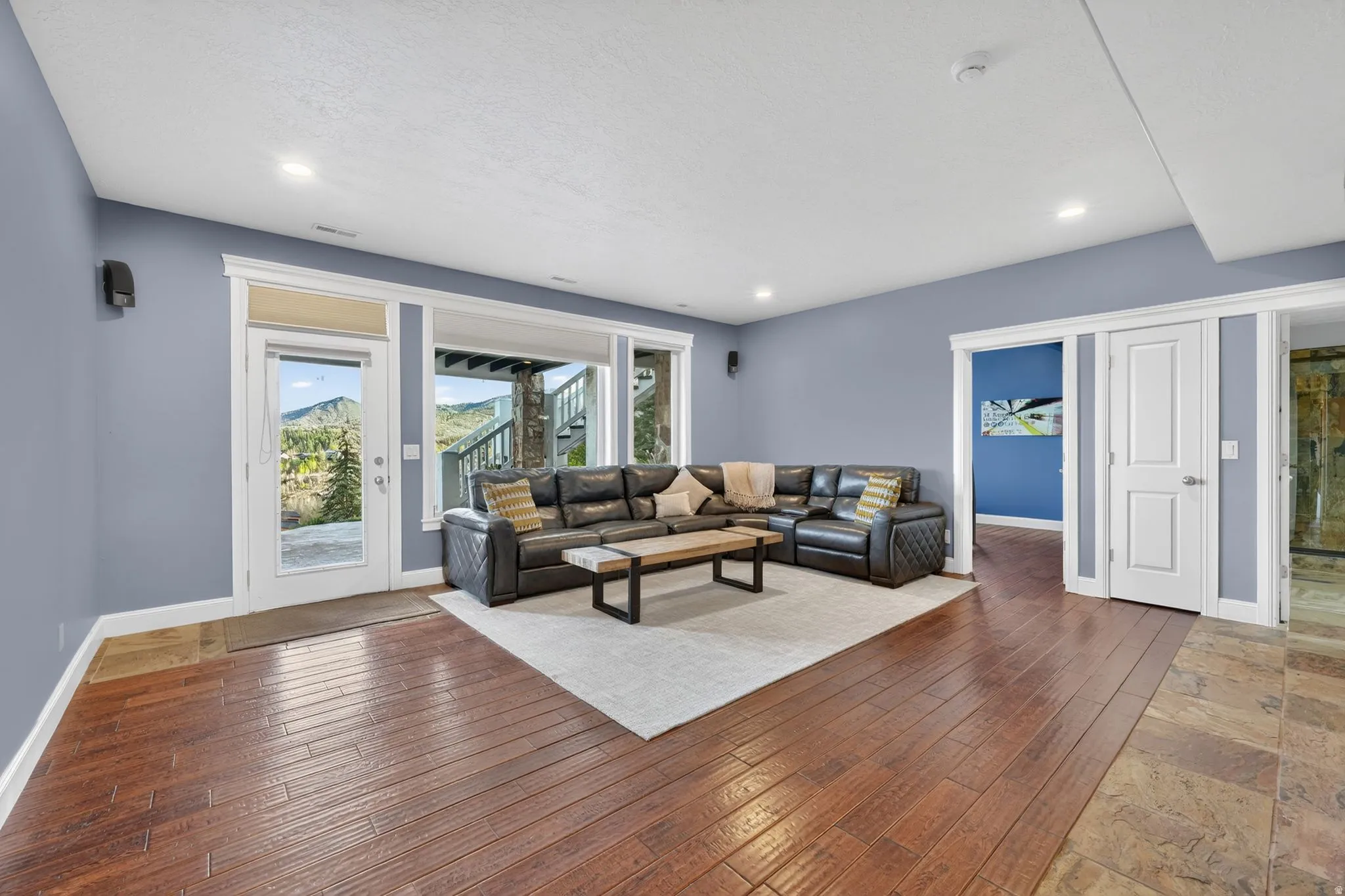 Living area with hardwood / wood-style flooring and recessed lighting