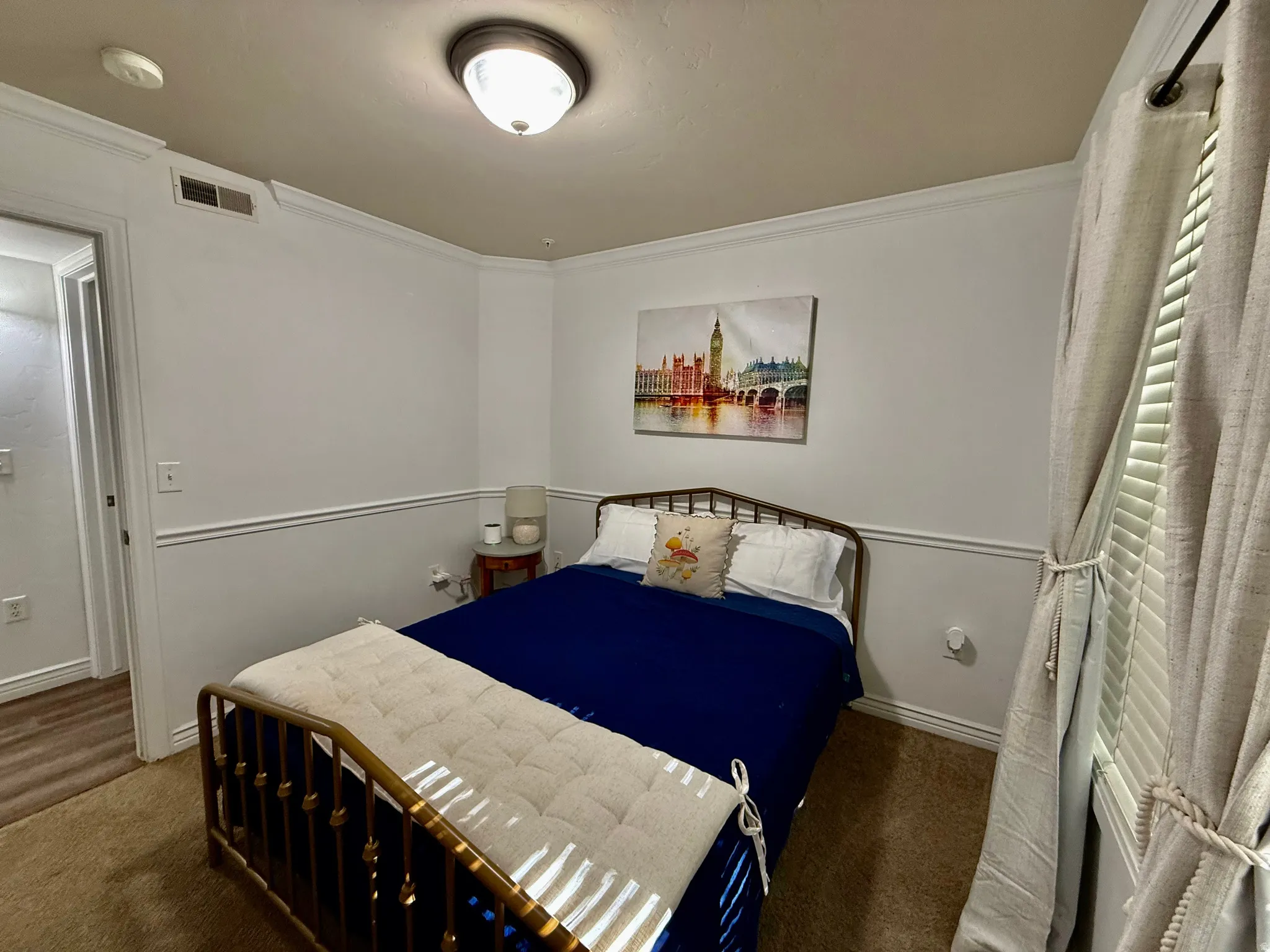 Bedroom featuring crown molding and carpet