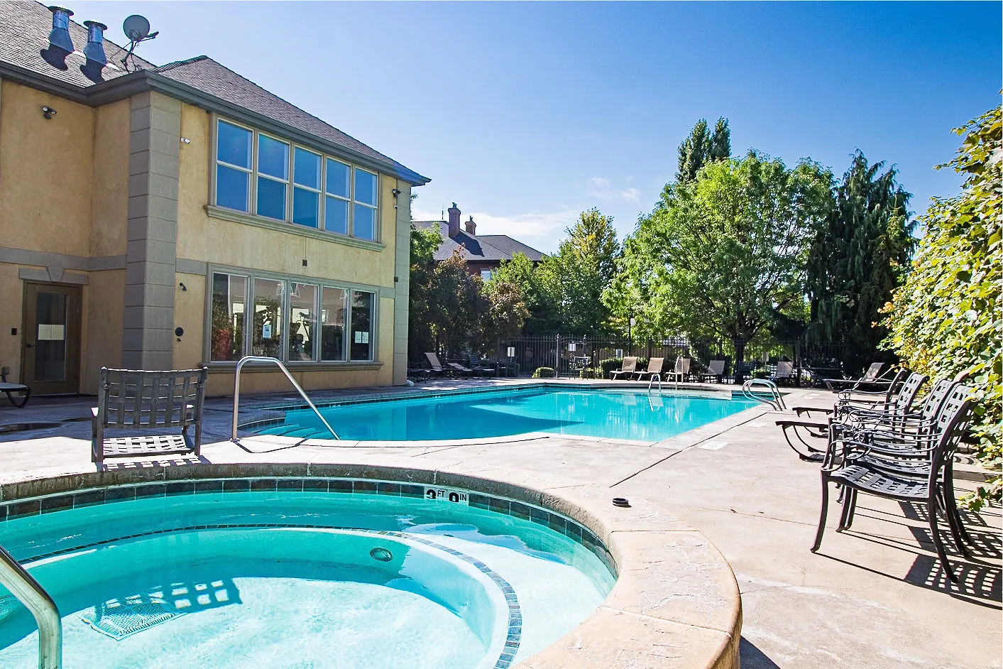 Community pool featuring a patio area and a hot tub