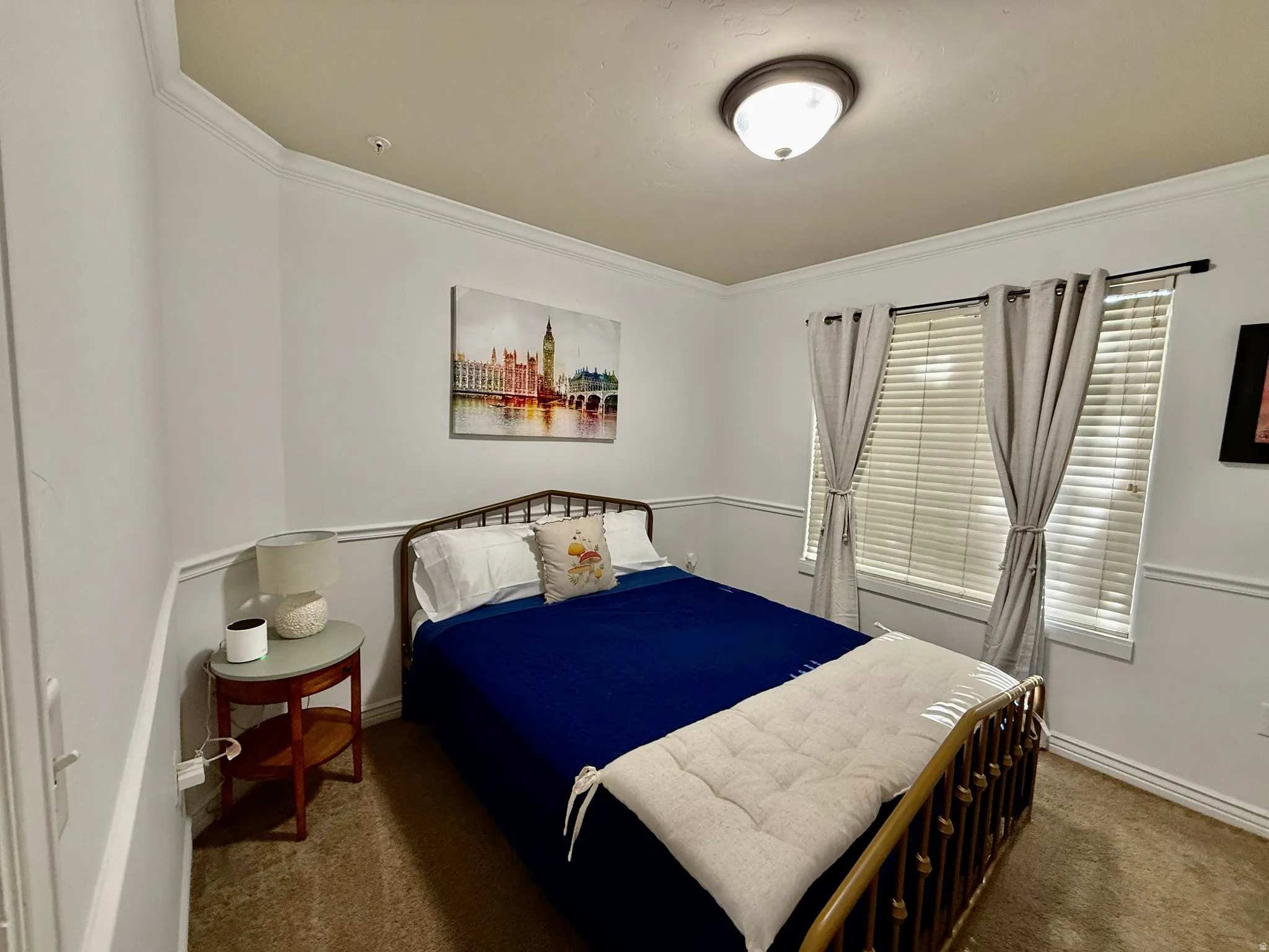 Bedroom featuring dark colored carpet and ornamental molding
