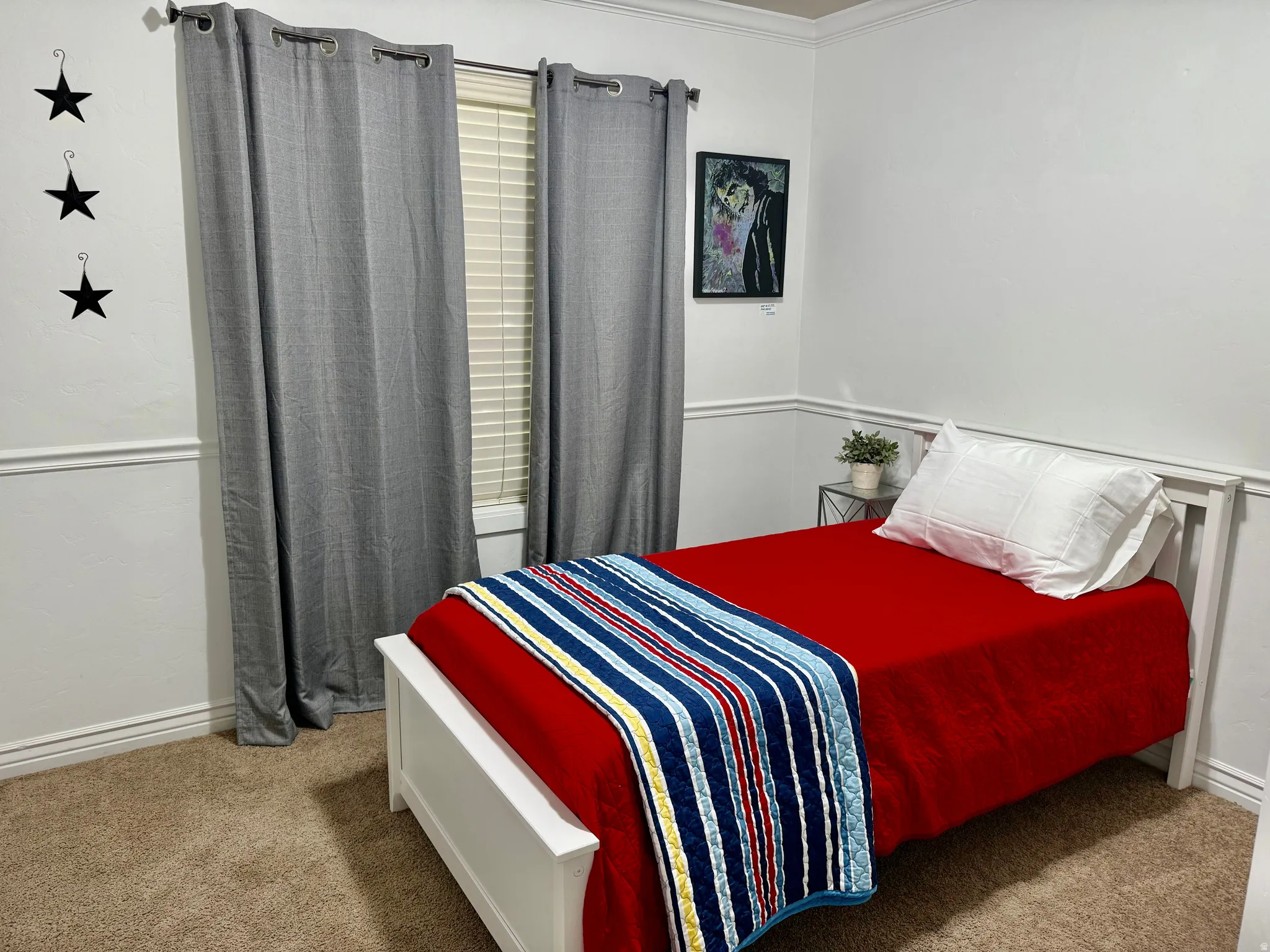 Bedroom with light colored carpet and ornamental molding