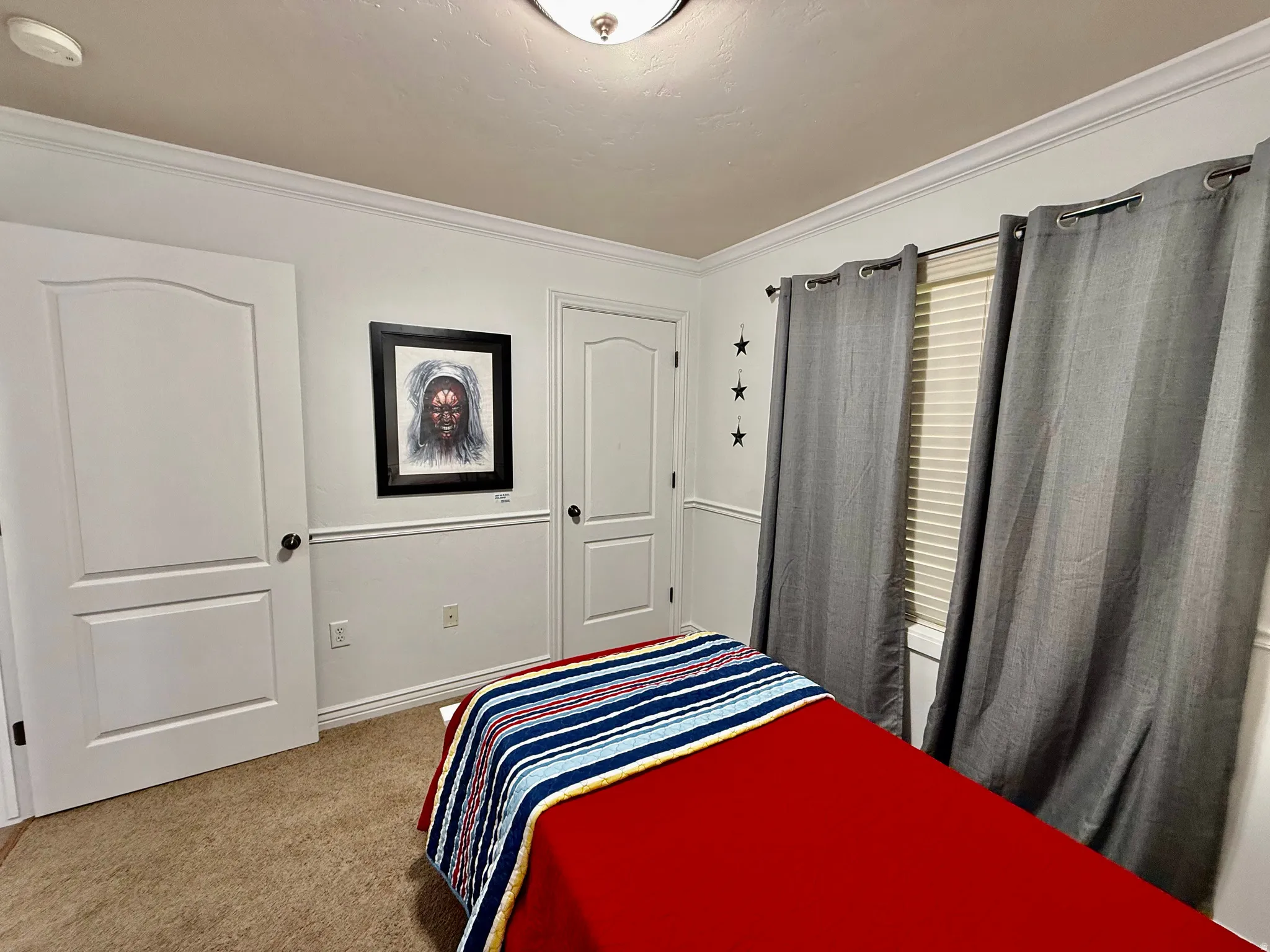 Bedroom featuring light carpet and crown molding