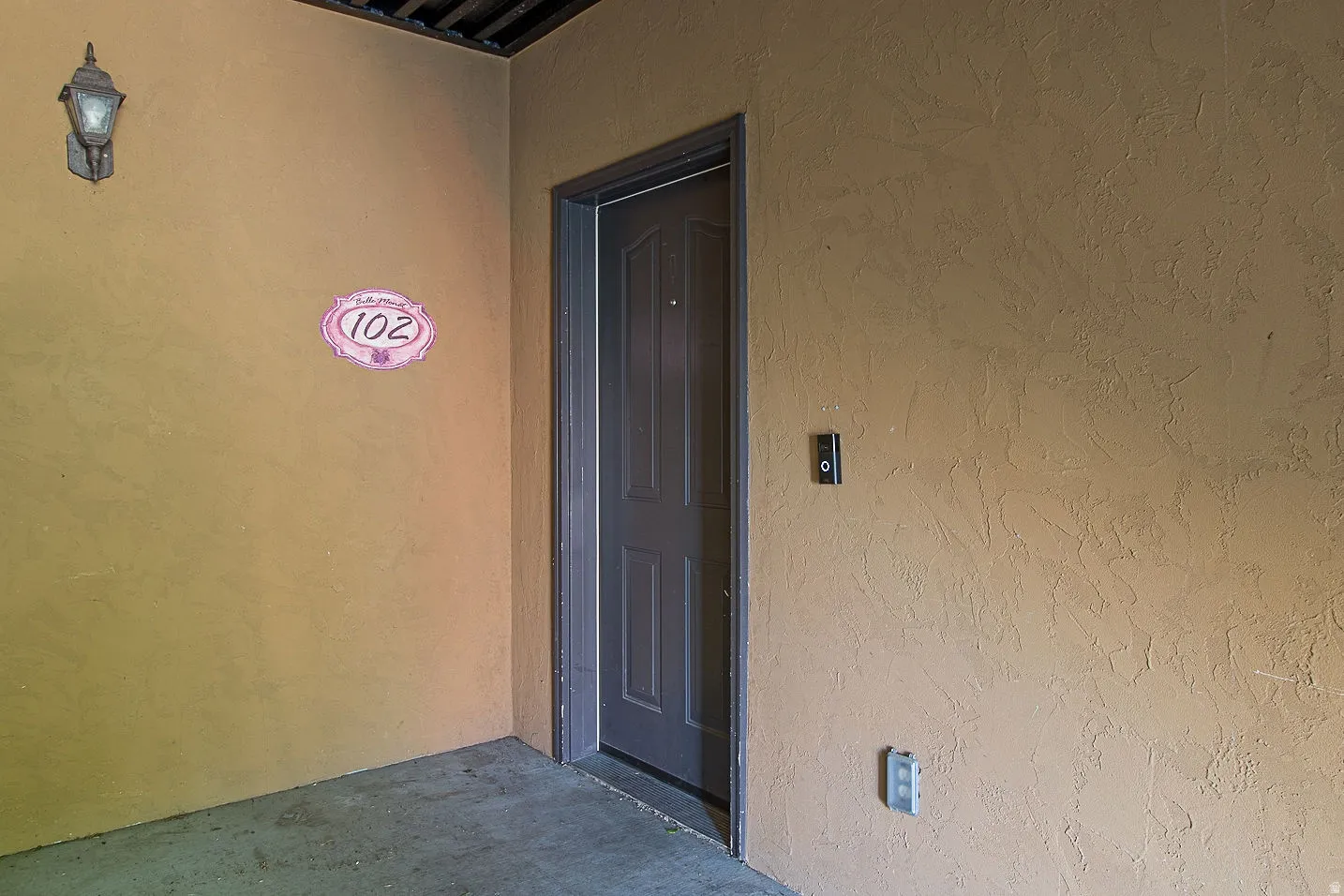 Entrance to property featuring a patio area and stucco siding