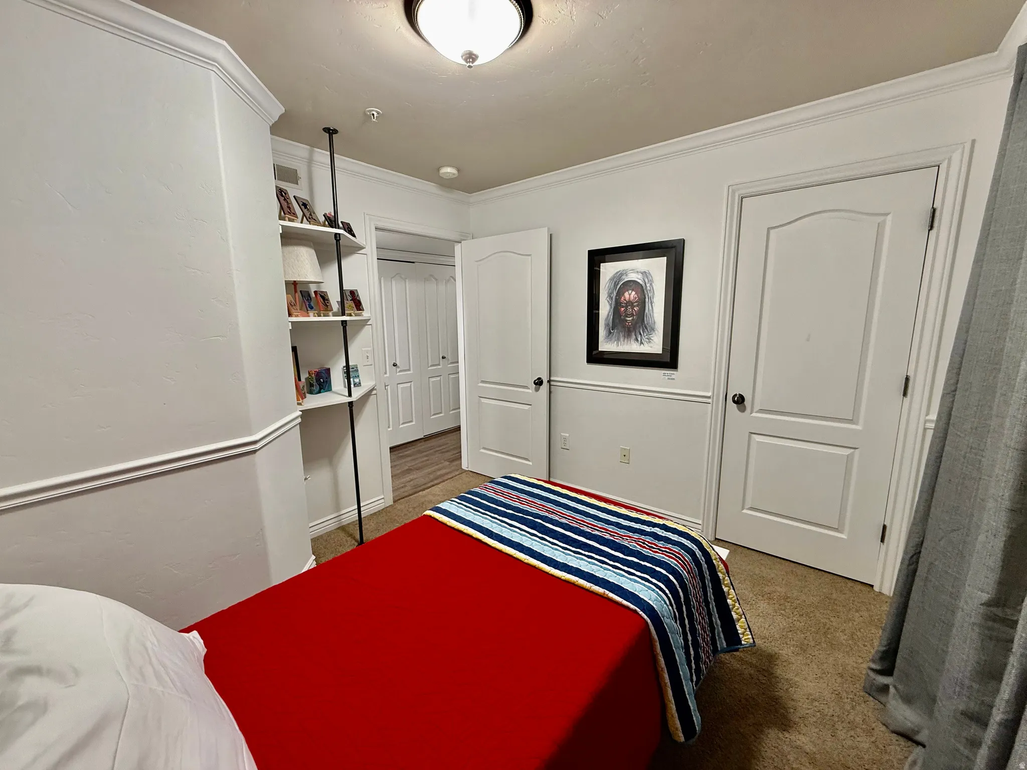 Bedroom featuring light colored carpet and crown molding