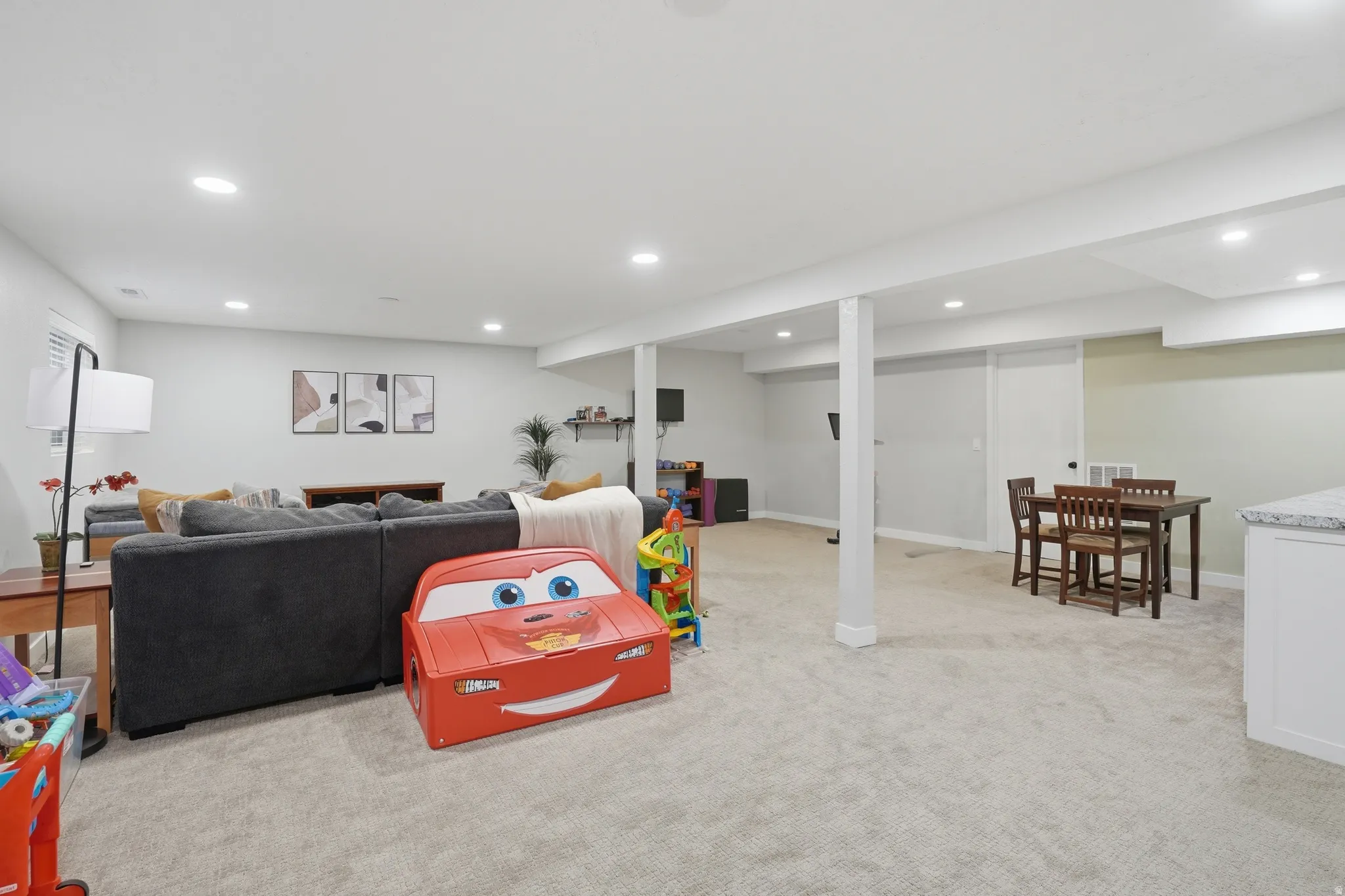 Recreation room featuring light colored carpet and recessed lighting