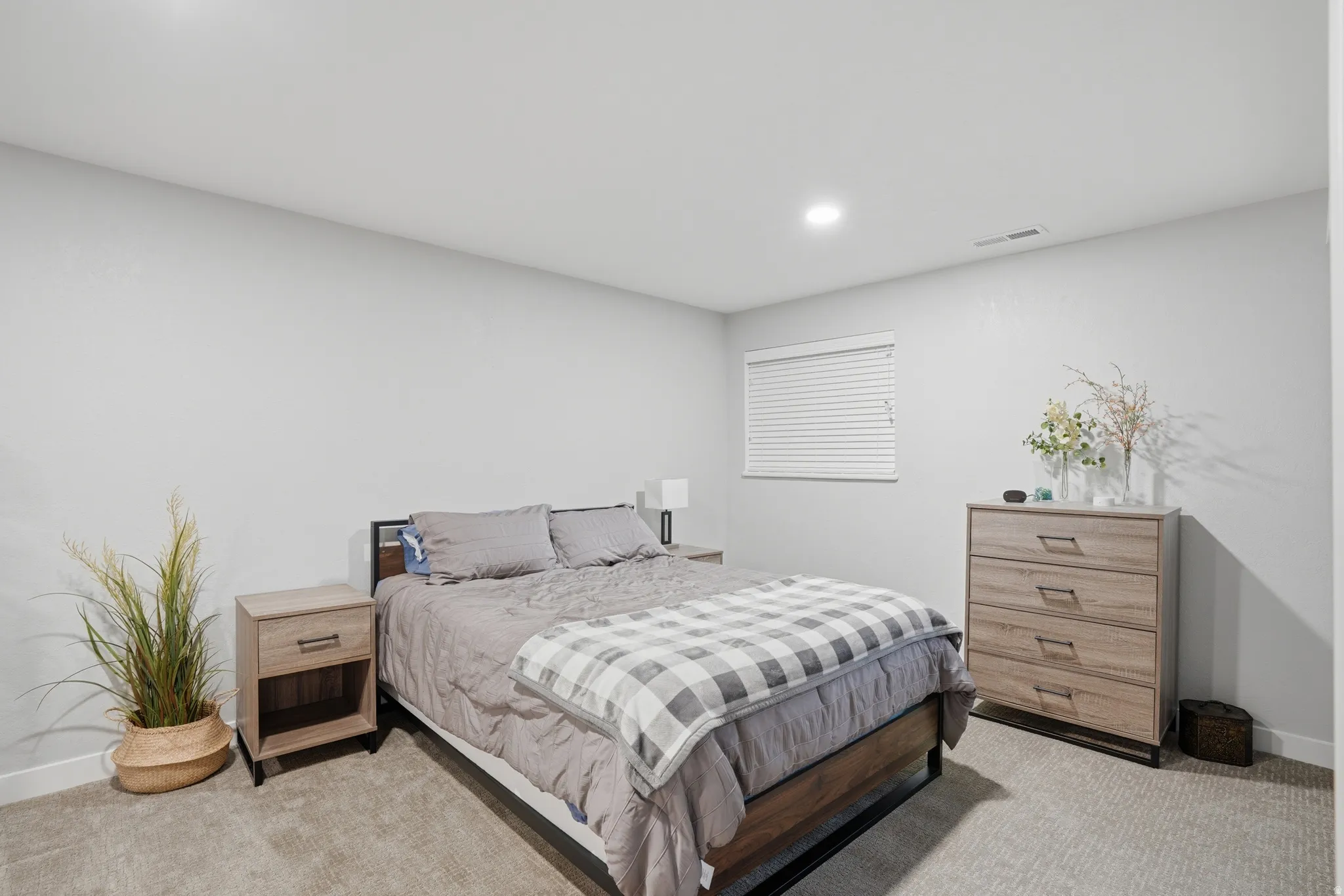 Bedroom with light carpet and recessed lighting