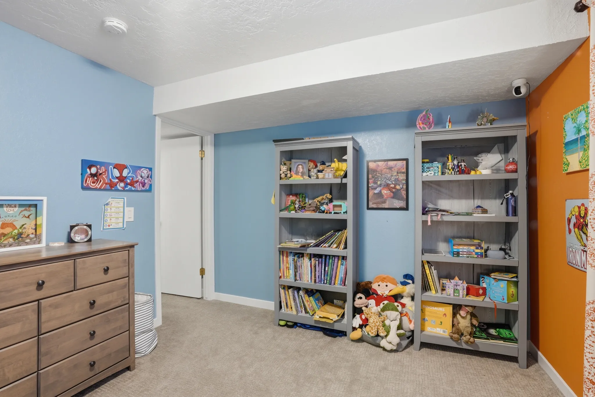 Recreation room with light carpet and a textured ceiling