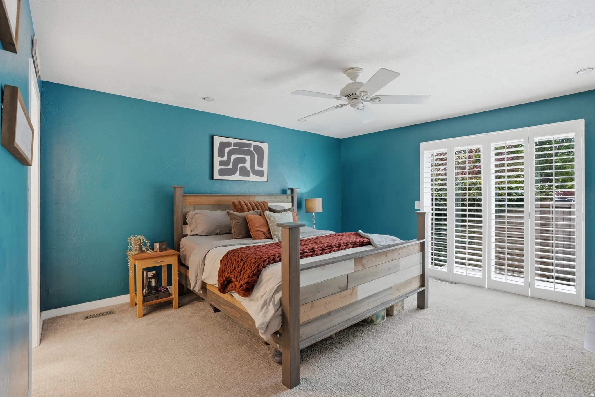 Bedroom featuring light colored carpet and ceiling fan