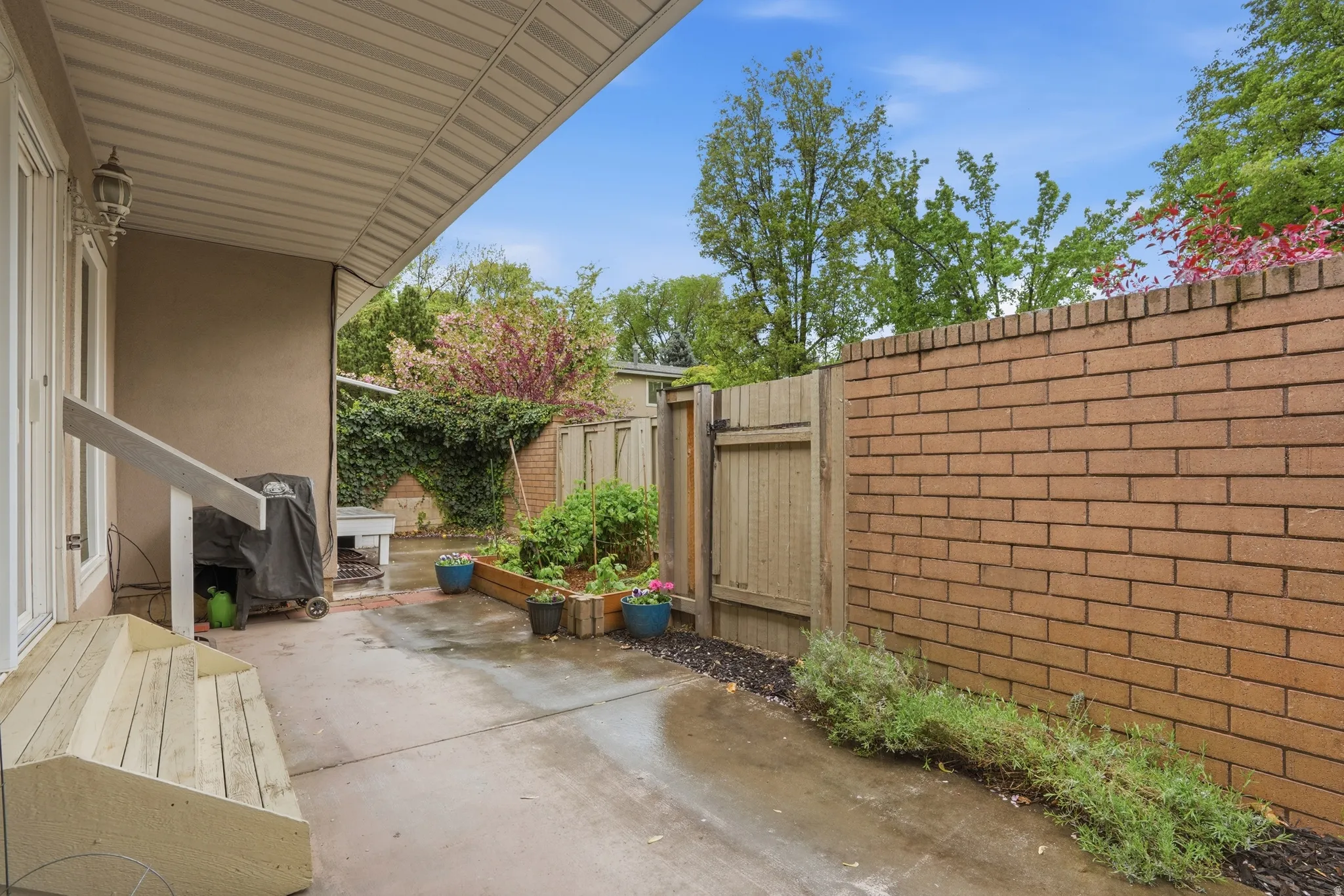 Fenced backyard with a patio area and grilling area