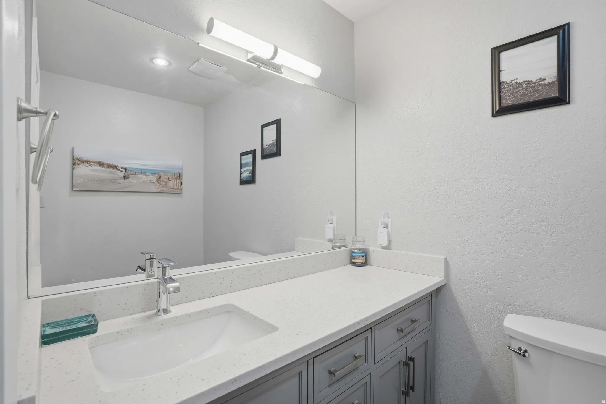 Bathroom featuring vanity and a textured wall