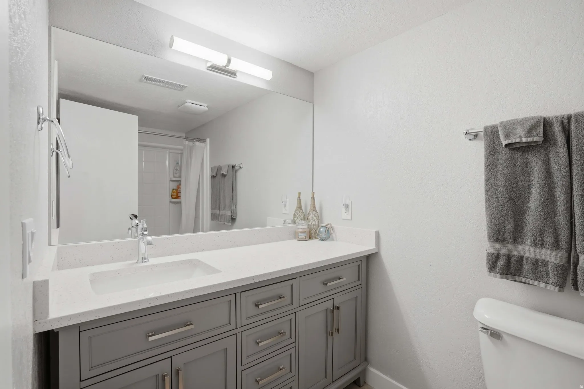 Full bath with vanity and a shower with curtain