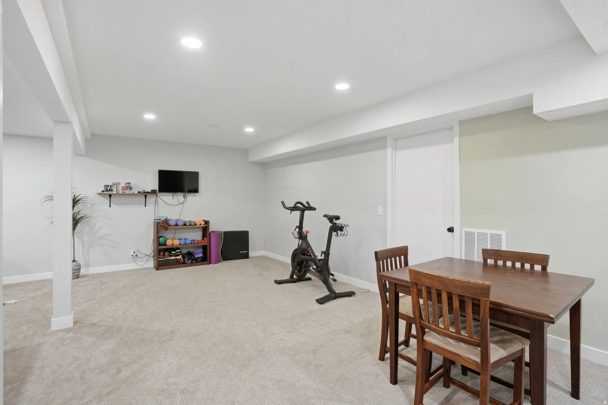 Workout room featuring light carpet and recessed lighting