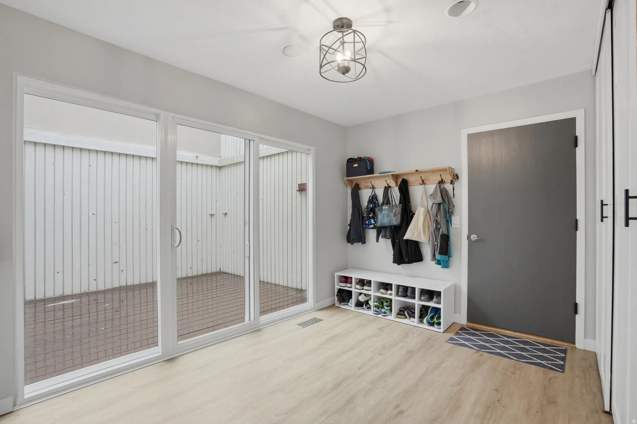 Mudroom with light wood finished floors and baseboards