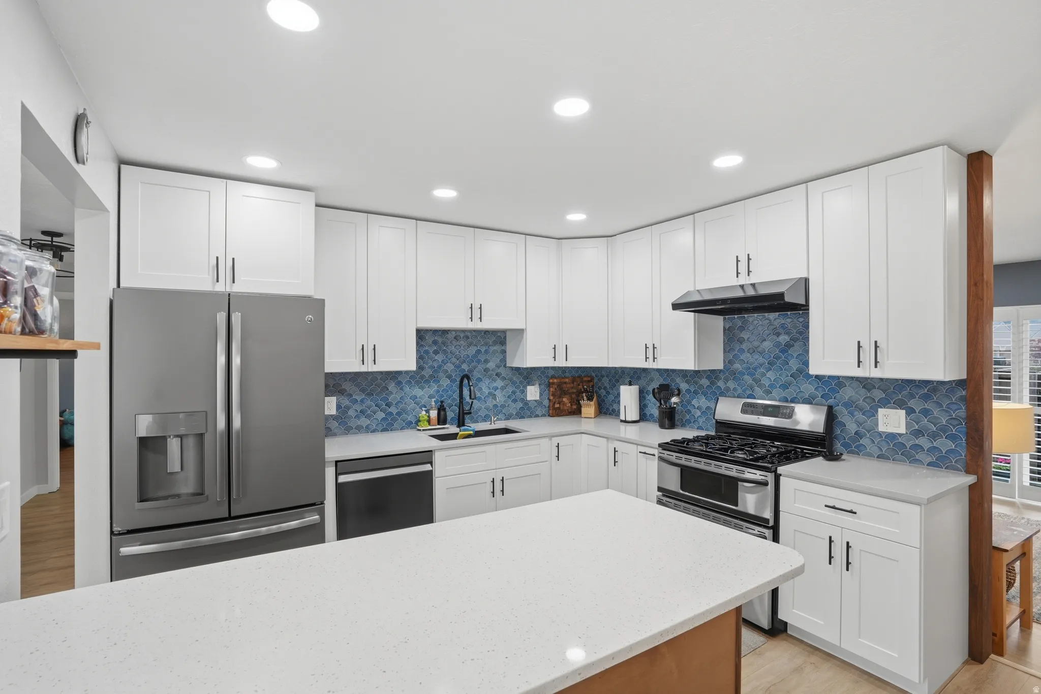 Kitchen with white cabinetry and recessed lighting