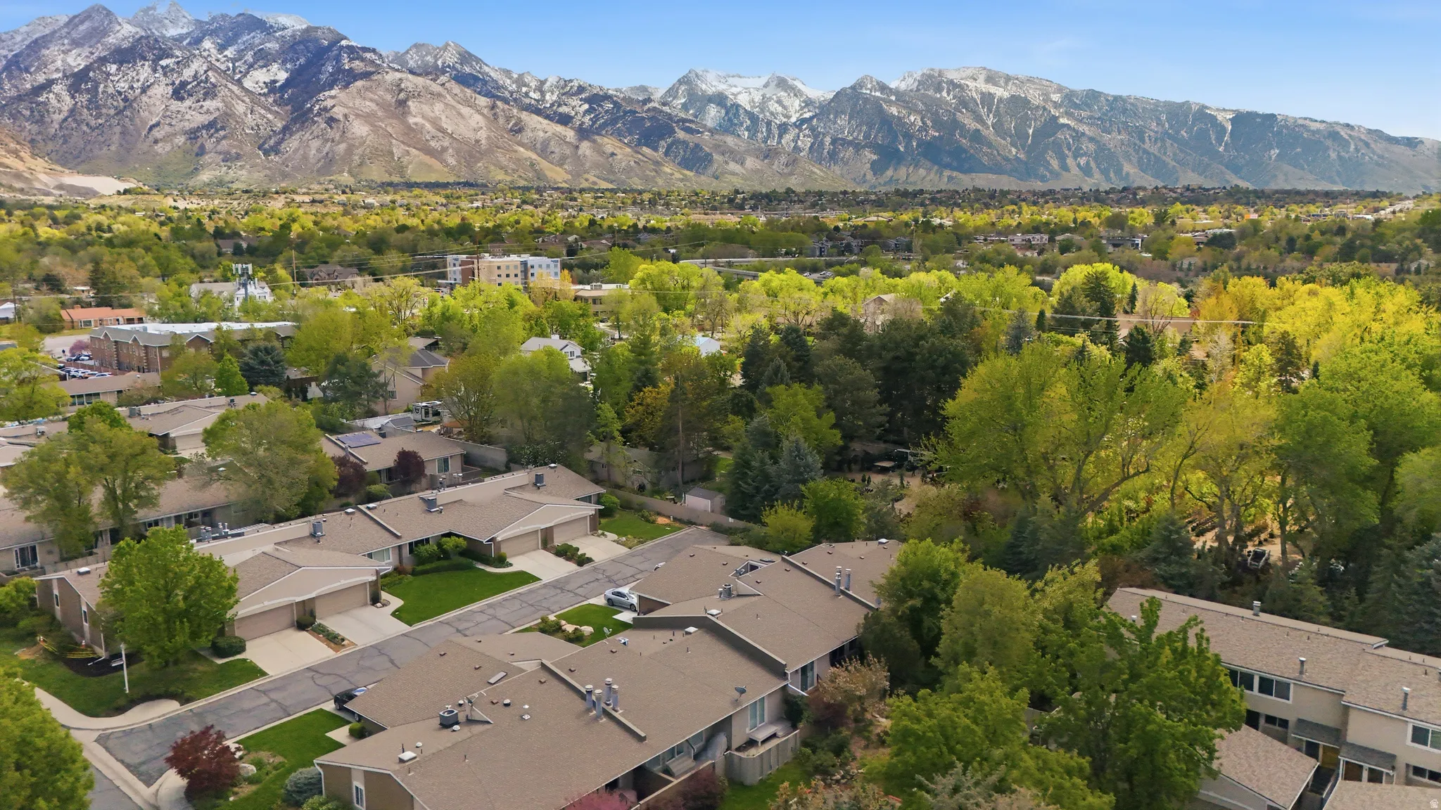 Aerial view of residential area featuring a mountainous background