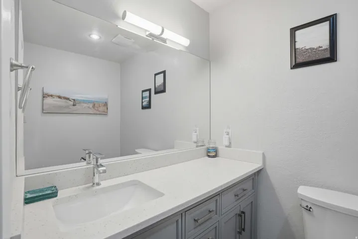 Bathroom featuring vanity and a textured wall