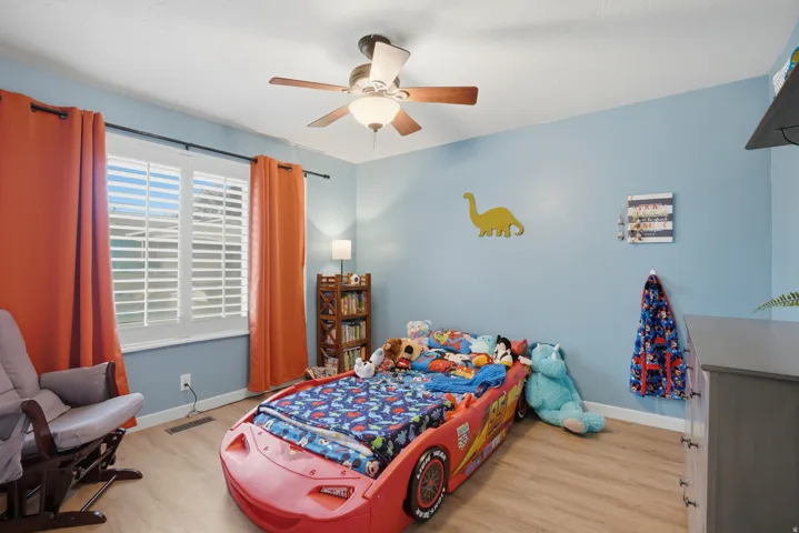 Bedroom featuring light wood-type flooring and a ceiling fan