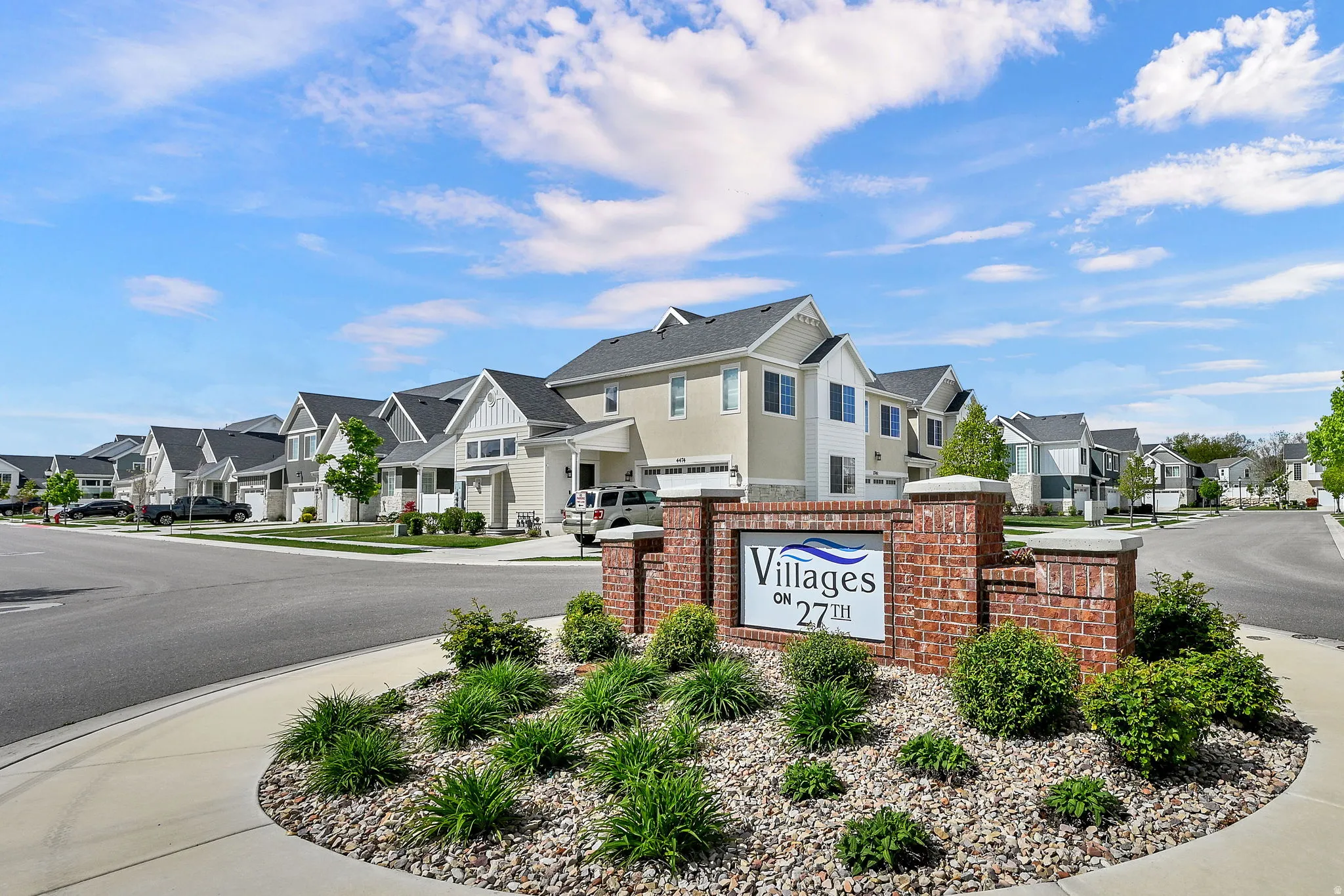Community / neighborhood sign featuring a residential view