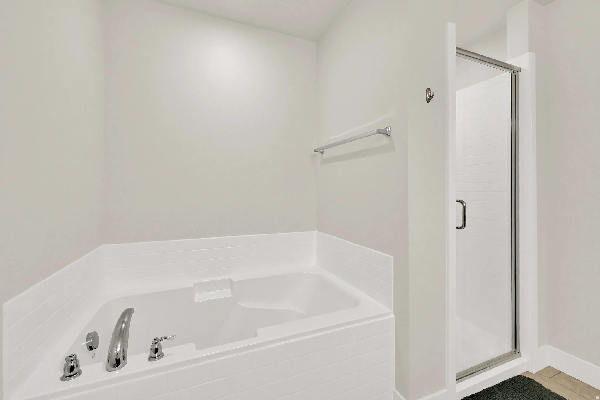 Bathroom featuring a stall shower and a bath