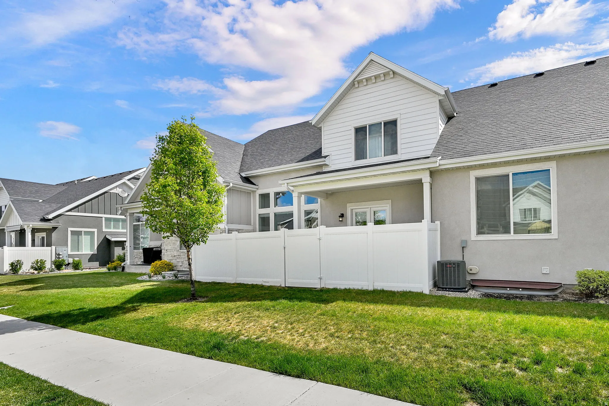 View of front of home featuring a shingled roof, board and batten siding, and stucco siding