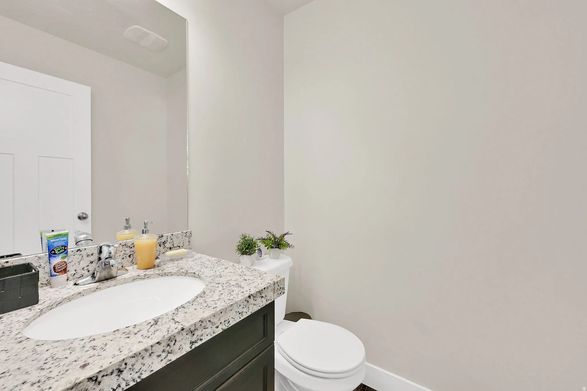 Bathroom featuring vanity and toilet