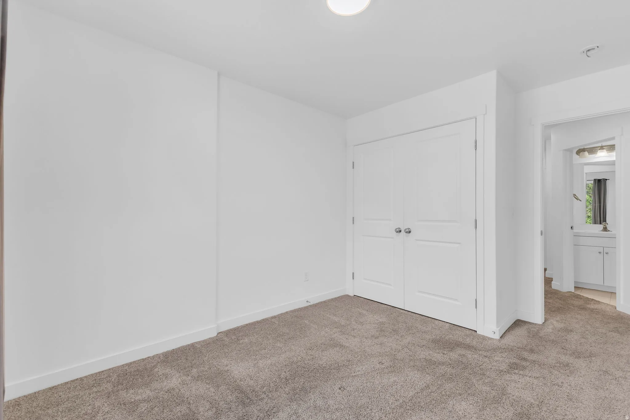 Unfurnished bedroom featuring carpet and a closet