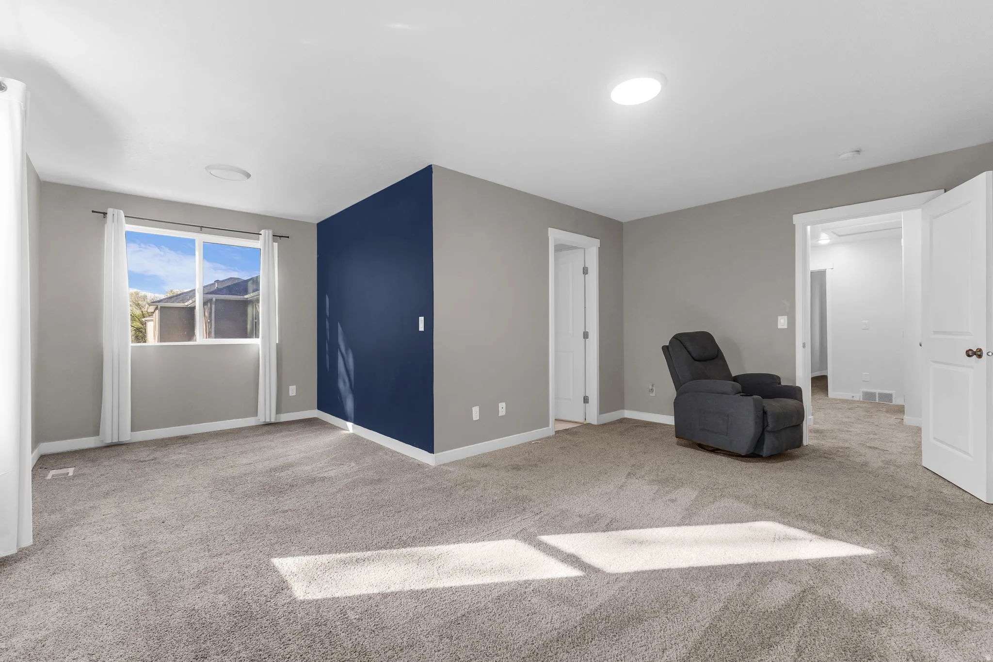 Unfurnished room with light carpet and baseboards